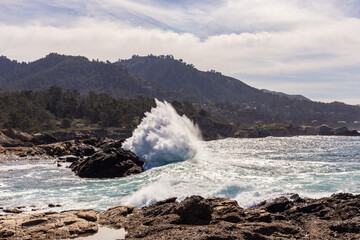 A view on Pacific ocean coast with blue sky and water and waves