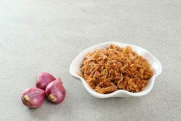 Indonesian crispy deep fried shallots or onion flakes (bawang goreng) in a small bowl.
