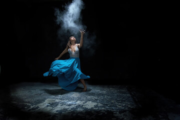 woman in a dress. young ballerina with a perfect body is dancing in a photo studio, dancers are...