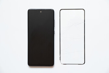 Phone and broken protective glass lies nearby on a white background, replacement of protective glass
