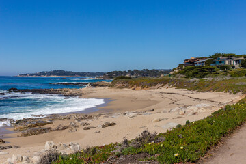A view on Pacific ocean coast with blue sky and water and waves