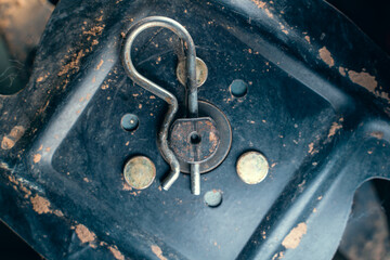 The spring cotter pin holds the axis of the tiller of the walk-behind tractor close-up