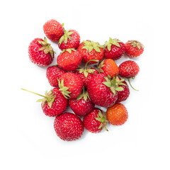 The fruits of ripe red strawberries with green stems are randomly isolated on a white background.