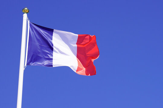 france flag french wave over a blue sky waving on mat
