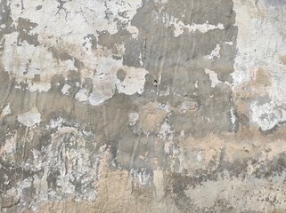 Wall fragment with scratches and cracks.vintage dirty exfoliating plaster Textured background peeling of colour wallpaper cement.The​ pattern​ of​ surface​ wall​ concrete​ for​ background.