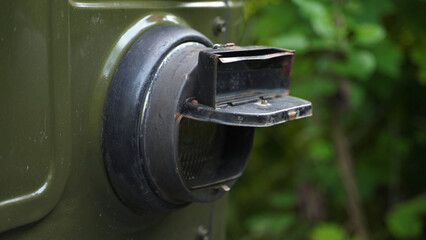 military truck light, close-up. military vehicles, transportation of soldiers. protection of car headlights. green military truck in the forest
