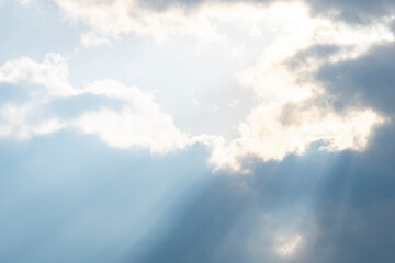 the sun's rays make their way through the dark clouds