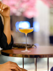 a woman and colorful cocktail