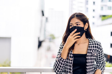 Fototapeta premium Young beautiful asian woman in quarantine for coronavirus wearing surgical mask face protection with social distancing at city.covid19 concept