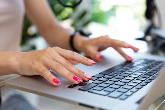 Close Up Of Woman Hands Typing On Laptop Keyboard At The Office