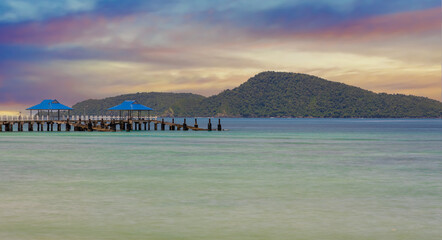 Colourful Skies Sunset over Rawai Beach in Phuket island Thailand. Lovely turquoise blue waters, lush green mountains colourful skies and beautiful views of Pa Tong Patong