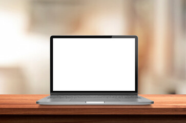 Portable notebook or laptop mockup on a wooden table  in blurry background.