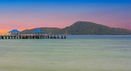 Colourful Skies Sunset over Rawai Beach in Phuket island Thailand. Lovely turquoise blue waters, lush green mountains colourful skies and beautiful views of Pa Tong Patong