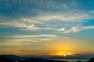 Fototapeta na wymiar 加太休暇村から見る淡路島に沈む夕日 