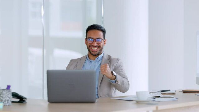 Excited business man winning and celebrating while reading email on laptop and happy about success and good news after sealing online deal. Attorney or lawyer overjoyed after victory on legal case