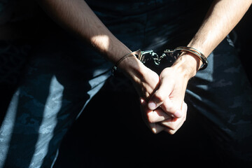 prisoner concept, Handcuffed hands of a prisoner in prison, Male prisoners were severely strained in the dark prison, violence,