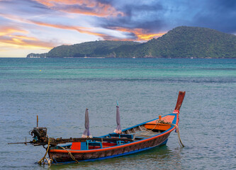 Colourful Skies Sunset over Rawai Beach in Phuket island Thailand. Lovely turquoise blue waters, lush green mountains colourful skies and beautiful views of Pa Tong Patong