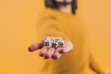 Isolated person holding random boardgame dices drawn by luck on a hand. High quality photo