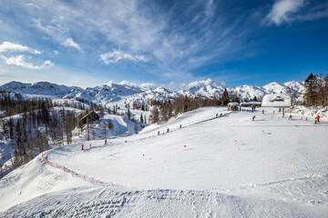 Bohinj, Slovenia - Vogel ski resort in Bohinj in Julian Alps on a sunny winter day with blue sky and clouds