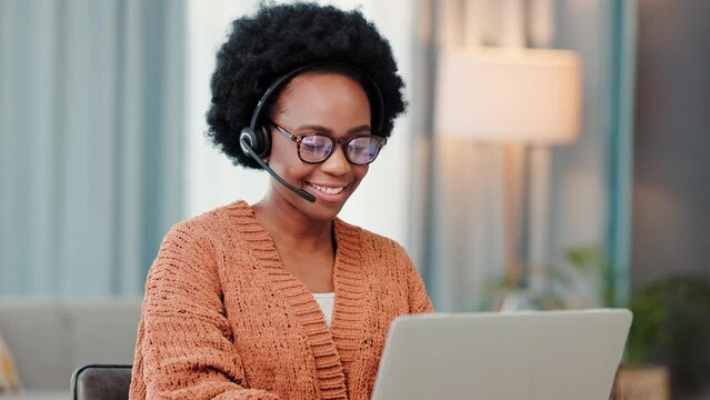 A freelance call center agent consulting a client while working from home. Happy and young African female customer service employees talking to a customer on a video call doing remote work