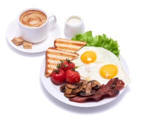 Fried eggs, bacon, tomato, toasted bread in ceramic plate and cup of coffee isolated on white background
