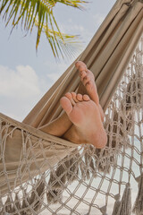 vacation, man tourist having rest in beach hammock in hotel, relaxation
