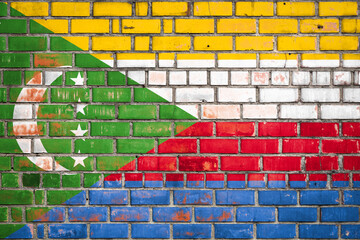 National  flag of the  Comoros  on a grunge brick background.