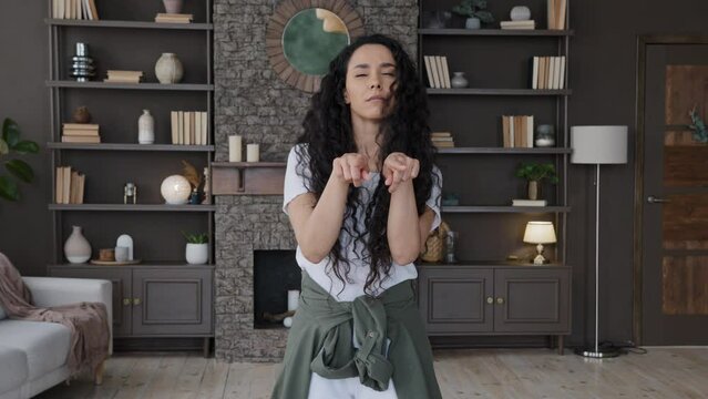 Joyful young woman blogger recording vlog for social network funny dancing shows trending movements trend challenge active girl vlogger looking at camera performs modern popular dance humor dances