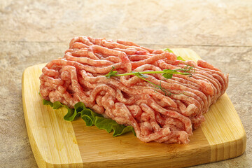 Raw minced pork meat over board