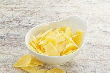 Sliced parmesan cheese heap in the bowl