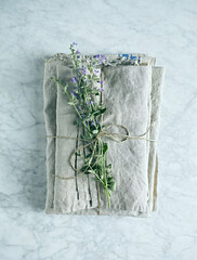 Folded linen cloths  with catnip flowers. Top view