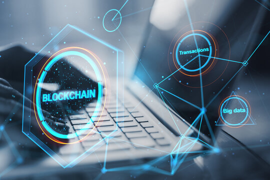 Close up of hands using laptop keyboard with creative polygonal blockchain hologram on blurry background. Technology, crypto, financial data and fintech concept. Double exposure.