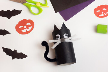 Step by step photo instruction Halloween craft. Step 10 Handmade decoration cat from toilet paper roll. Reuse concept
