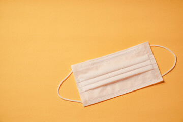 Surgical mask on yellow background, Health care, protection virus, covid-19, coronavirus, sickess concept.