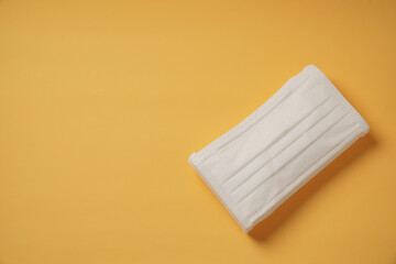 Surgical mask on yellow background, Health care, protection virus, covid-19, coronavirus, sickess concept.