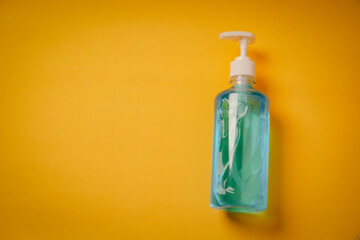 Medical gel bottle on yellow background