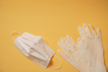 Surgical mask on yellow background