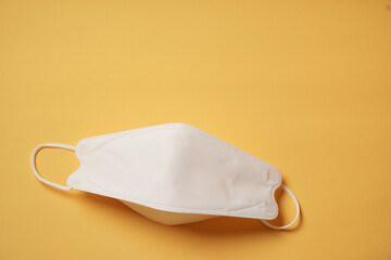 Surgical mask on yellow background, Health care, protection virus, covid-19, coronavirus, sickess concept.