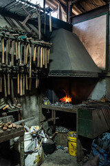 Close up view of heated metal and fire oven. Blacksmith in the production process of other metal...