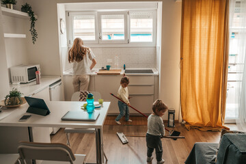 Family of three people doing housework together