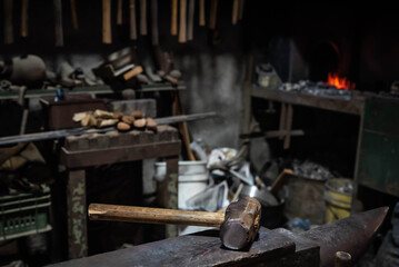 Close up view of heated metal and anvil. Blacksmith in the production process of other metal...