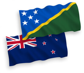 National vector fabric wave flags of New Zealand and Solomon Islands isolated on white background. 1 to 2 proportion.