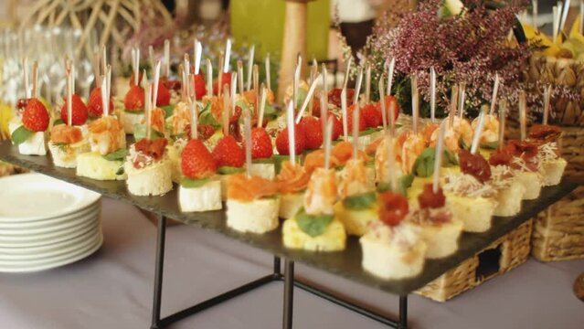Beautifully decorated catering banquet table with snack canape in restaurant or hotel. catering service, event celebratoin corporate birthday kids party or wedding. 