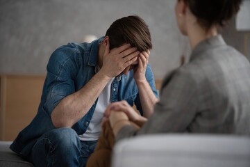 Psychologist talking with patient on therapy session.