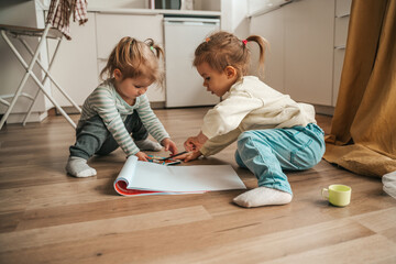 Cute female children playing in the kitchen