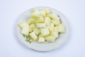 Honeydew melon. Whole fresh ripe sweet fruit with a sliced juicy piece of cut. 