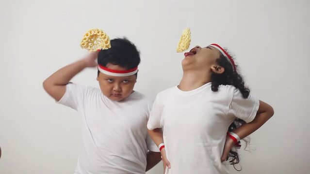Asian kids celebrating indonesian independence day with cracker eating contest. The excitement of children in welcoming independence day concept