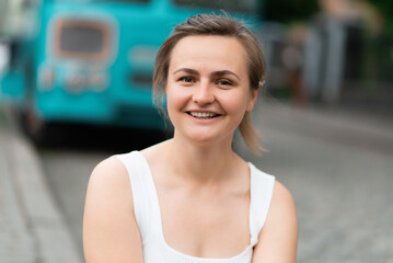 Close-up portrait of a happy woman in the city