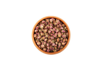 Dried rose buds in ceramic plate on white background, top view. Pink Rose buds used in herbal medicine and culinary as aromatic ingredient