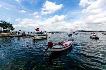 Fototapeta na wymiar blue sky with natural white clouds by the seaside. fishing boats are ready to sail